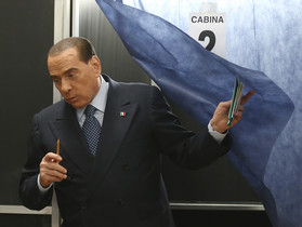 Berlusconi sale de la cabina donde ha emitido su voto, el domingo.