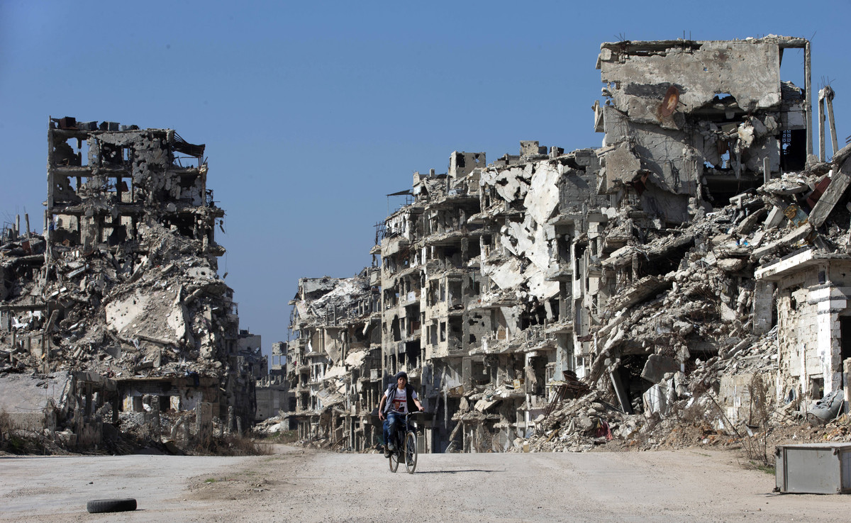 joven-pasa-bicicleta-ayer-entre-los-edificios-destruidos-ciudad-vieja-homs-siria-1457700307570.jpg