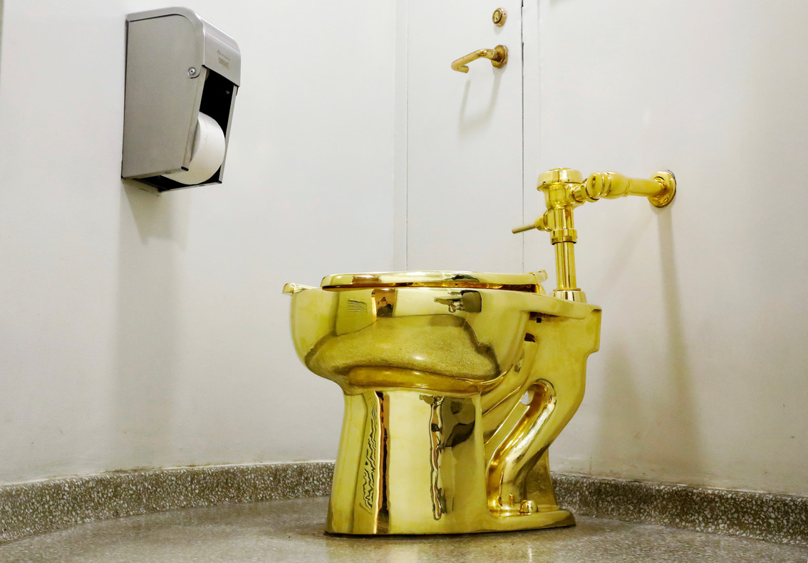 FILE PHOTO: Maurizio Cattelanâ¿¿s â¿¿America,â¿¿ a fully functional solid gold toilet is seen at The Guggenheim Museum in New York