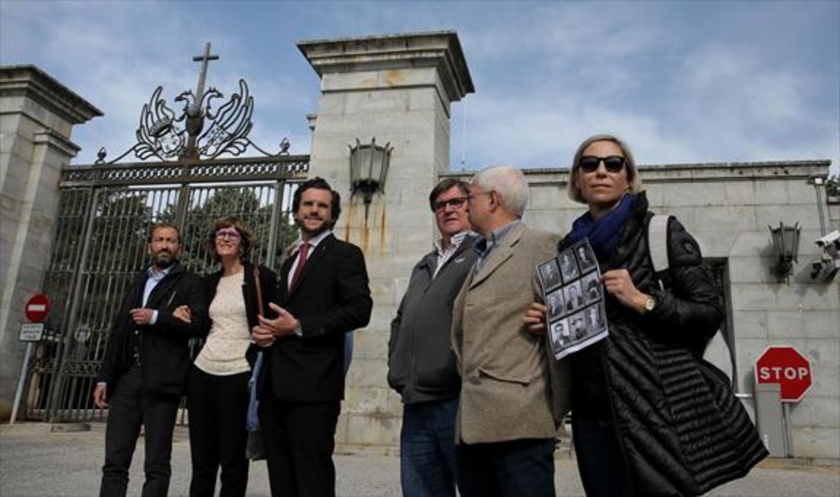 Familiares de víctimas de la guerra civil, frente a la entrada a la Basílica del Valle de los Caídos el pasado 23 de abril. En el centro, su abogado, Eduardo Ranz.